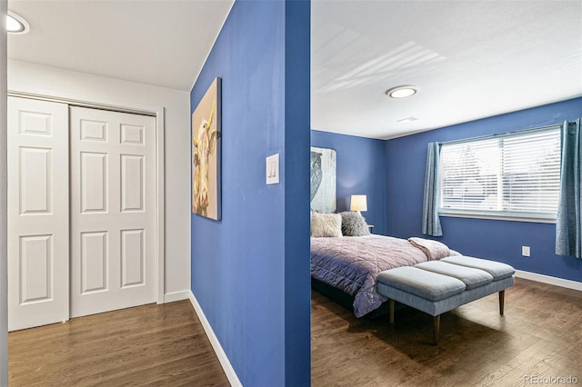 bedroom featuring a closet and dark hardwood / wood-style flooring