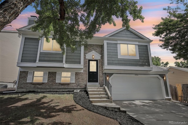 19954 E Dartmouth Ave, Aurora, CO 80013 - view of front facade with concrete driveway, an attached garage, and a chimney