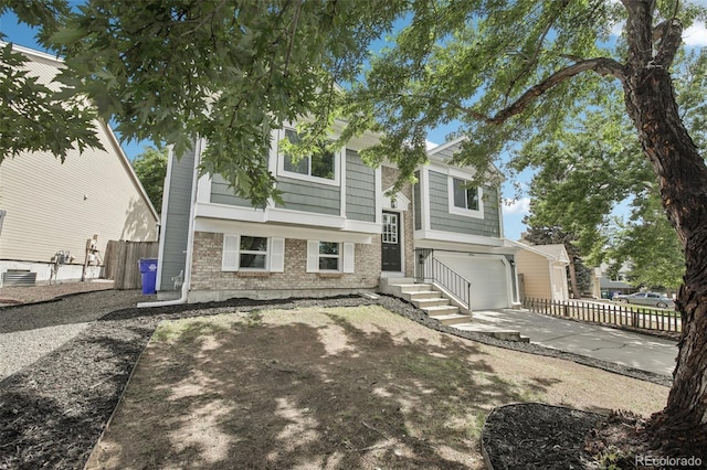 19954 E Dartmouth Ave, Aurora, CO 80013 - view of front of home with brick siding, an attached garage, and driveway