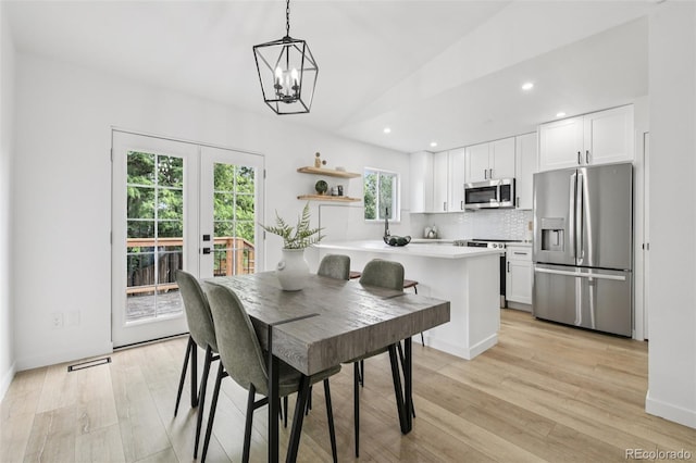 19954 E Dartmouth Ave, Aurora, CO 80013 - dining room with recessed lighting, a chandelier, light wood-style flooring, lofted ceiling, and french doors