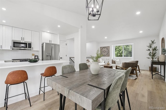 19954 E Dartmouth Ave, Aurora, CO 80013 - dining area with light wood-style floors, recessed lighting, and a chandelier
