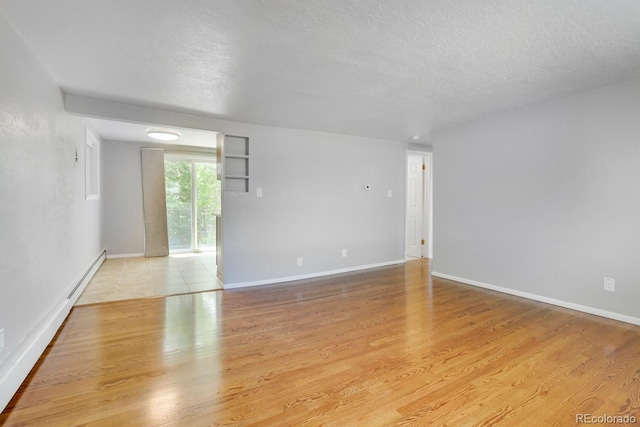 10491 W 7th Pl, Lakewood, CO 80215 - unfurnished room featuring a textured ceiling, light wood finished floors, and baseboards