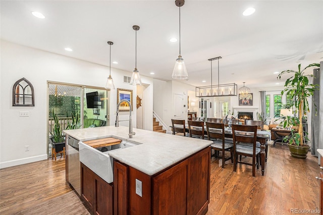 3357 N Akron Ct, Denver, CO 80238 - kitchen with stainless steel dishwasher, dark wood-style floors, open floor plan, recessed lighting, and light countertops