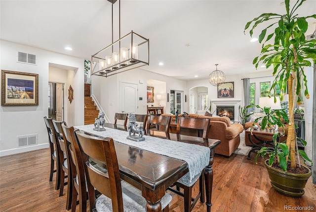 3357 N Akron Ct, Denver, CO 80238 - dining space featuring wood finished floors, stairway, recessed lighting, a chandelier, and a glass covered fireplace