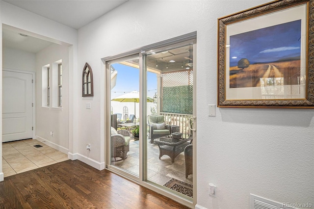 3357 N Akron Ct, Denver, CO 80238 - doorway to outside featuring wood finished floors and baseboards