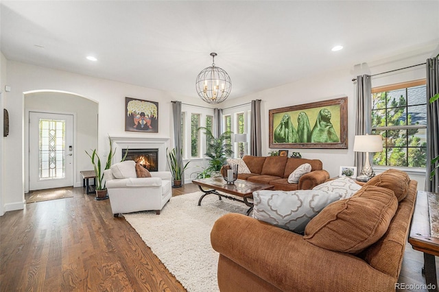 3357 N Akron Ct, Denver, CO 80238 - living room with healthy amount of natural light, wood finished floors, a glass covered fireplace, a chandelier, and recessed lighting