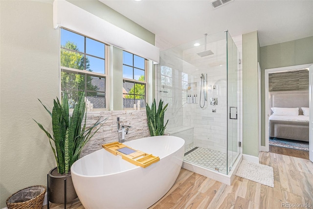 3357 N Akron Ct, Denver, CO 80238 - ensuite bathroom featuring a stall shower, a soaking tub, wood finished floors, and recessed lighting