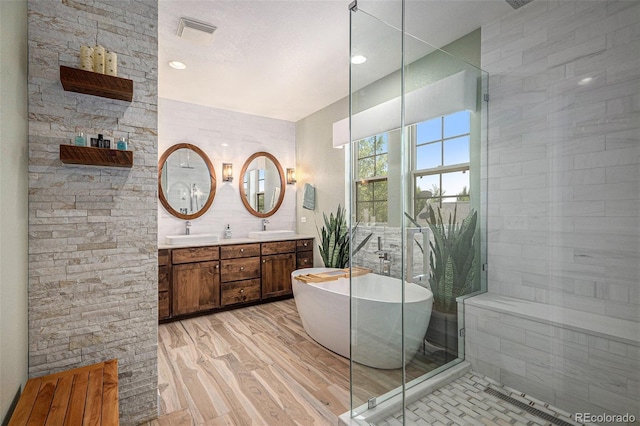 3357 N Akron Ct, Denver, CO 80238 - full bath with a freestanding tub, double vanity, a tile shower, and wood finished floors