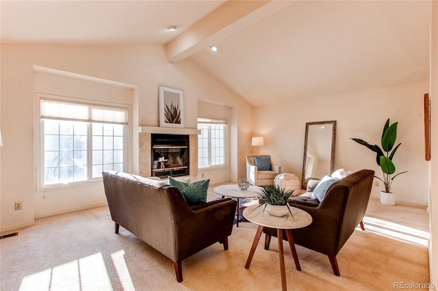 1530 S Quebec Way Unit 29, Denver, CO 80231 - living area featuring light carpet, a wealth of natural light, lofted ceiling with beams, and a glass covered fireplace