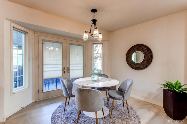 1530 S Quebec Way Unit 29, Denver, CO 80231 - dining area featuring french doors, light wood-style flooring, and a healthy amount of sunlight