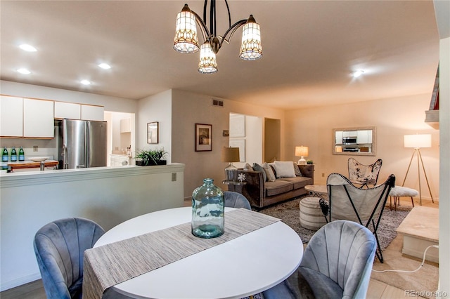 1530 S Quebec Way Unit 29, Denver, CO 80231 - dining room featuring visible vents, a chandelier, and recessed lighting