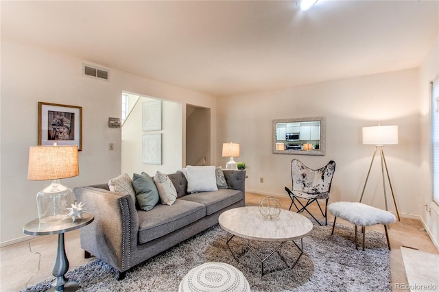 1530 S Quebec Way Unit 29, Denver, CO 80231 - living area featuring light colored carpet, visible vents, and baseboards