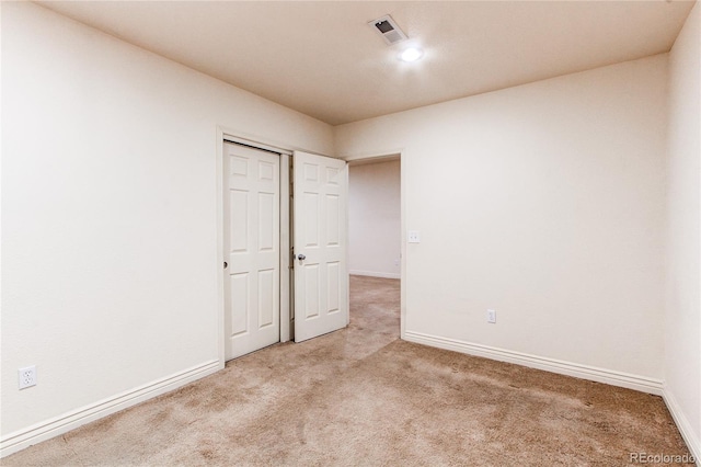 1530 S Quebec Way Unit 29, Denver, CO 80231 - unfurnished bedroom with baseboards, visible vents, and light colored carpet
