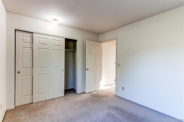 1530 S Quebec Way Unit 29, Denver, CO 80231 - unfurnished bedroom with light colored carpet, a closet, and baseboards