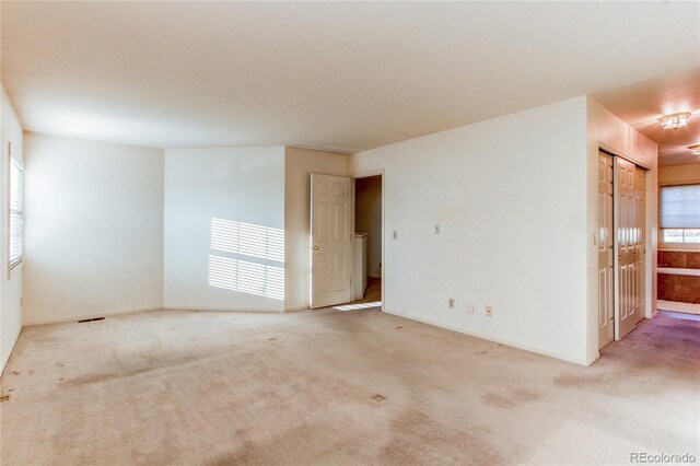 1530 S Quebec Way Unit 29, Denver, CO 80231 - carpeted spare room featuring washer / clothes dryer and baseboards