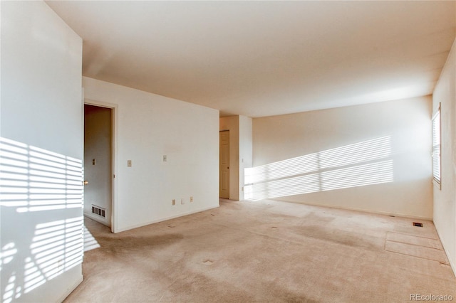 1530 S Quebec Way Unit 29, Denver, CO 80231 - empty room with visible vents, baseboards, and light carpet