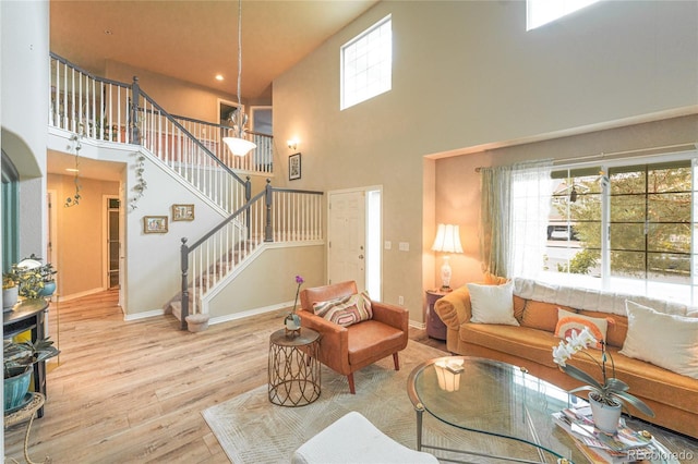 919 Taylor Ln, Erie, CO 80516 - living area featuring a high ceiling, wood finished floors, and stairway