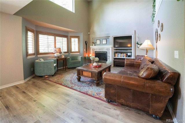 919 Taylor Ln, Erie, CO 80516 - living area with a high ceiling, wood-type flooring, and a fireplace