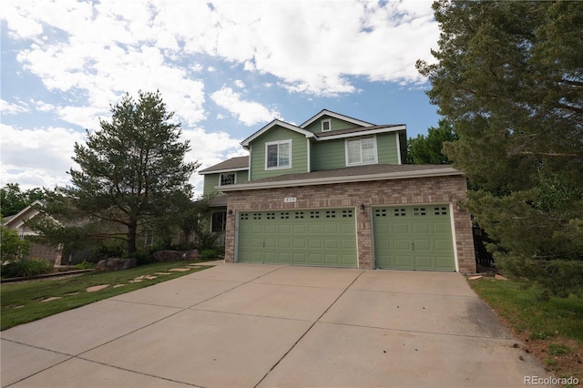 919 Taylor Ln, Erie, CO 80516 - traditional-style home featuring a garage, driveway, and brick siding