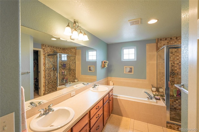 919 Taylor Ln, Erie, CO 80516 - full bath with a shower stall, a garden tub, double vanity, tile patterned floors, and a textured ceiling