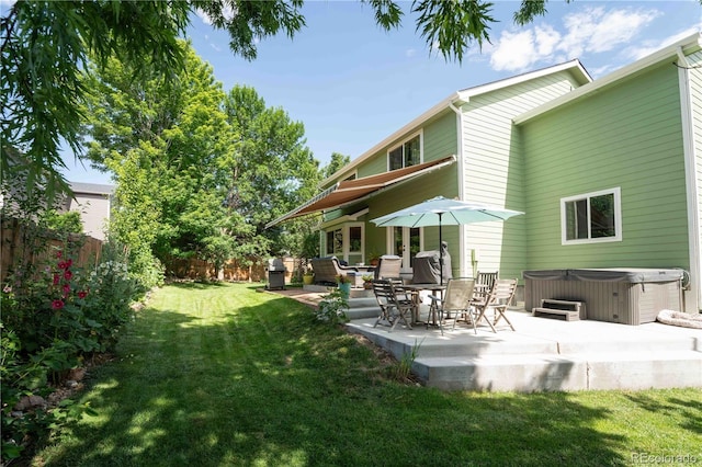 919 Taylor Ln, Erie, CO 80516 - fenced backyard featuring a hot tub and a patio area