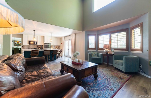 919 Taylor Ln, Erie, CO 80516 - living area featuring light wood-style floors and a high ceiling