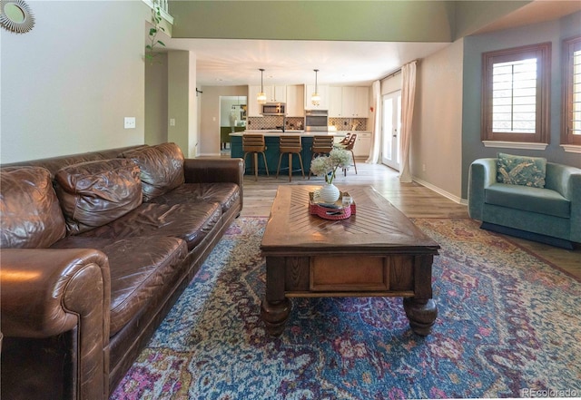 919 Taylor Ln, Erie, CO 80516 - living room featuring light wood-type flooring and baseboards