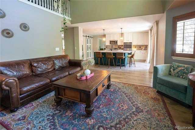 919 Taylor Ln, Erie, CO 80516 - living room featuring light wood-type flooring and a towering ceiling