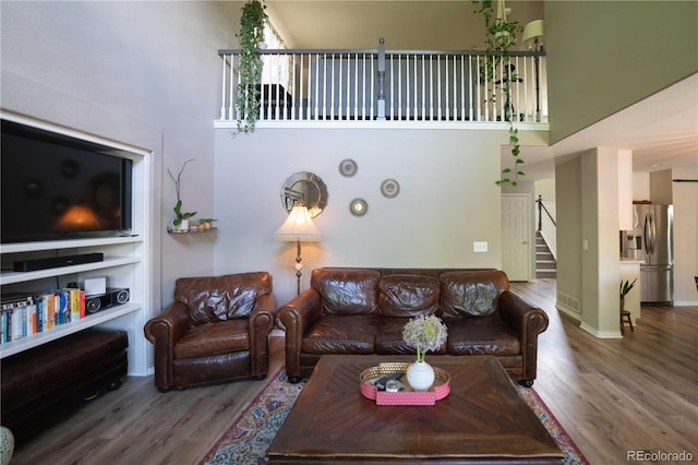 919 Taylor Ln, Erie, CO 80516 - living room featuring a high ceiling, wood finished floors, and stairs