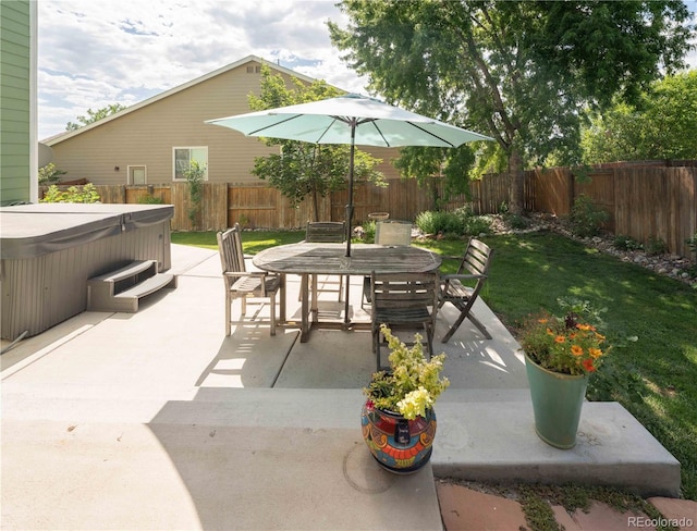 919 Taylor Ln, Erie, CO 80516 - fenced backyard featuring a hot tub, a patio area, and outdoor dining area