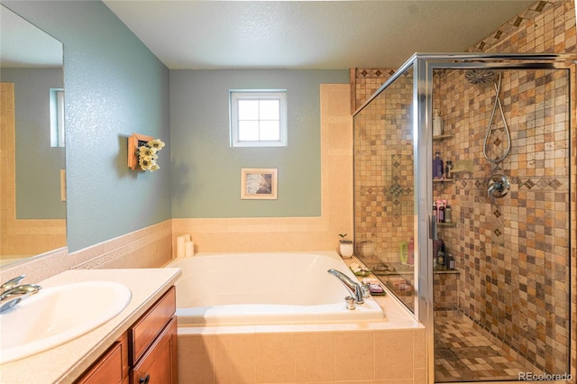 919 Taylor Ln, Erie, CO 80516 - bathroom featuring a bath, a stall shower, vanity, and a textured ceiling