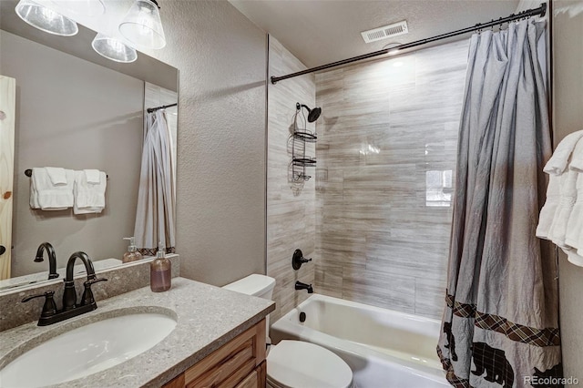 full bathroom featuring vanity, shower / tub combo, a textured ceiling, and toilet