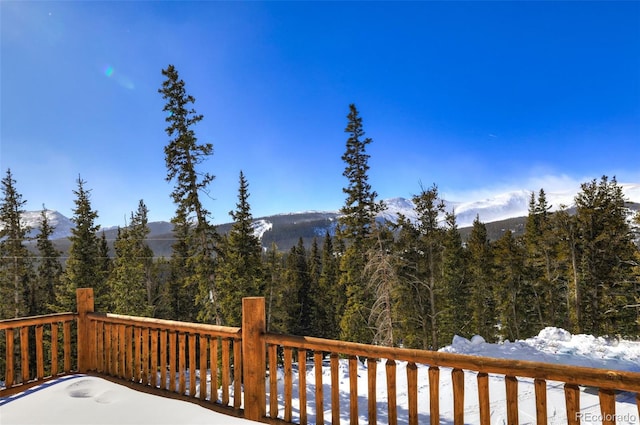 snow covered deck featuring a mountain view