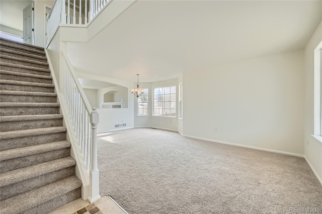 interior space with an inviting chandelier and carpet floors