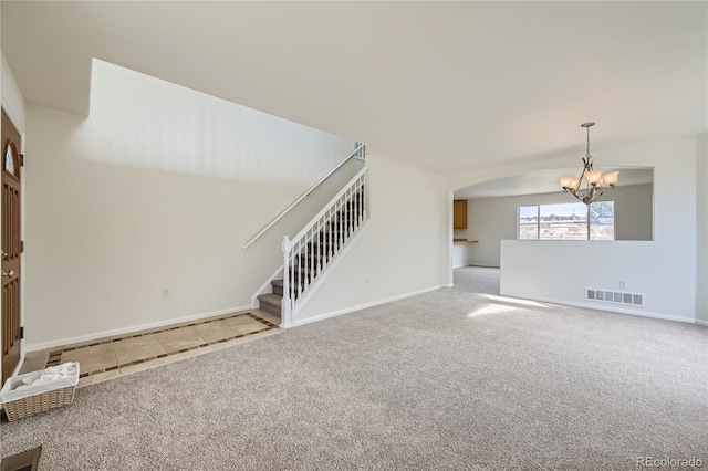 unfurnished living room with light carpet and a notable chandelier