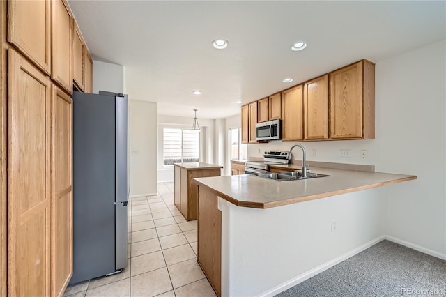 kitchen featuring light tile patterned flooring, sink, hanging light fixtures, kitchen peninsula, and stainless steel appliances