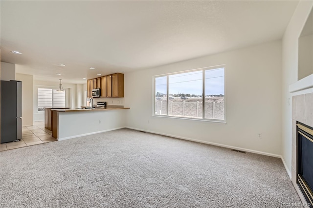 unfurnished living room featuring light carpet