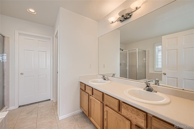 bathroom featuring tile patterned flooring, vanity, and a shower with shower door