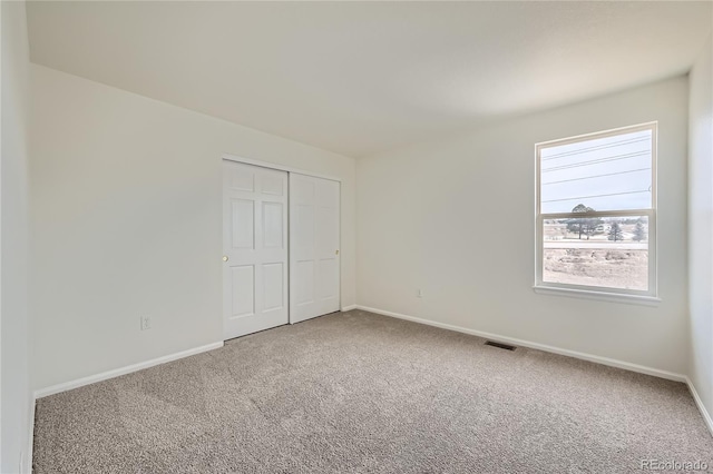 unfurnished bedroom with a closet and carpet