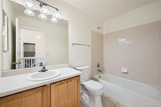 full bathroom featuring vanity, tile patterned floors, toilet, and tiled shower / bath