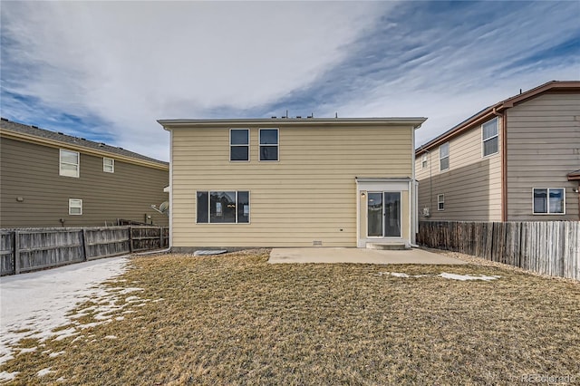 rear view of property with a yard and a patio area