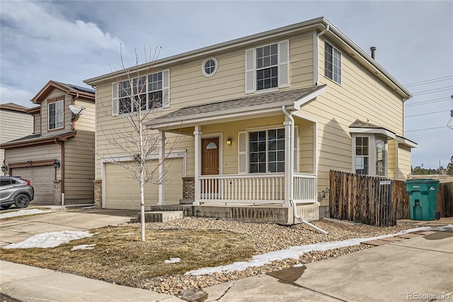 view of front property featuring a porch and a garage