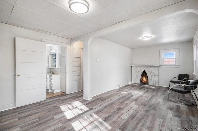 unfurnished room with hardwood / wood-style flooring and a fireplace