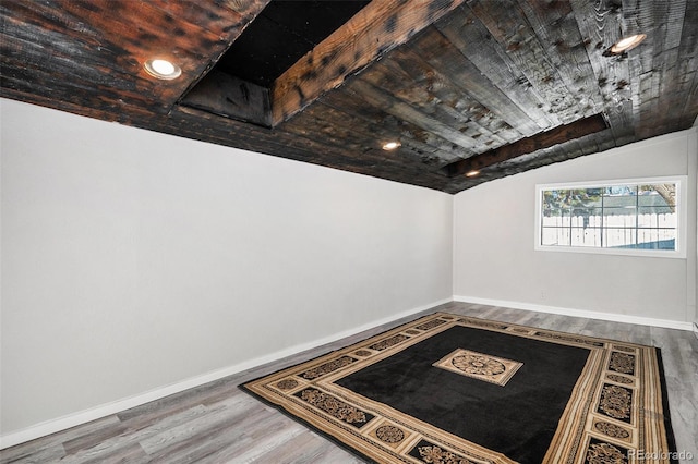 interior space with hardwood / wood-style flooring, wooden ceiling, and vaulted ceiling