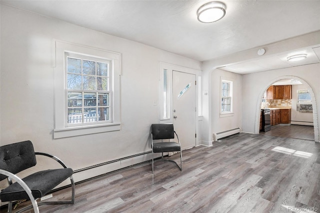 entryway with a baseboard heating unit and light hardwood / wood-style flooring