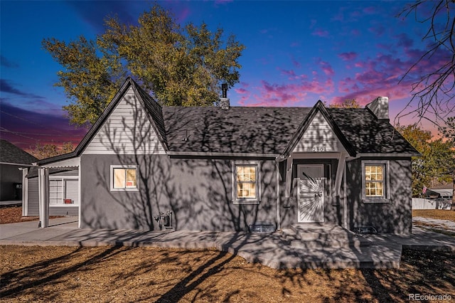 tudor home featuring a patio