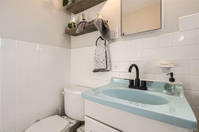 3224 Troy St, Aurora, CO 80011 - half bath featuring tile walls, toilet, vanity, and backsplash