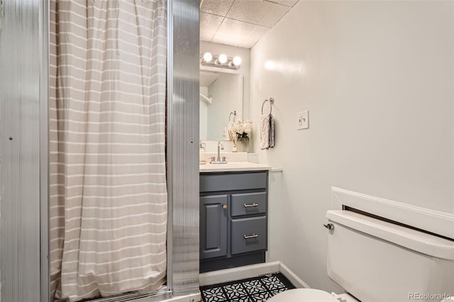 3224 Troy St, Aurora, CO 80011 - full bath featuring toilet, vanity, a paneled ceiling, and baseboards