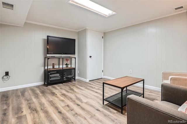 3224 Troy St, Aurora, CO 80011 - living area featuring wood finished floors, ornamental molding, and baseboards
