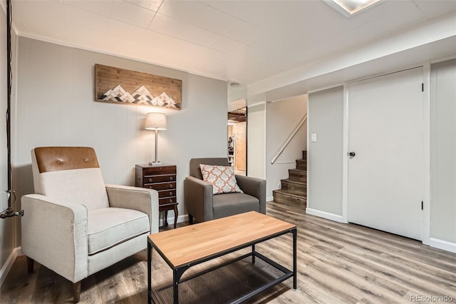 3224 Troy St, Aurora, CO 80011 - living area featuring light wood-style floors, stairway, and baseboards